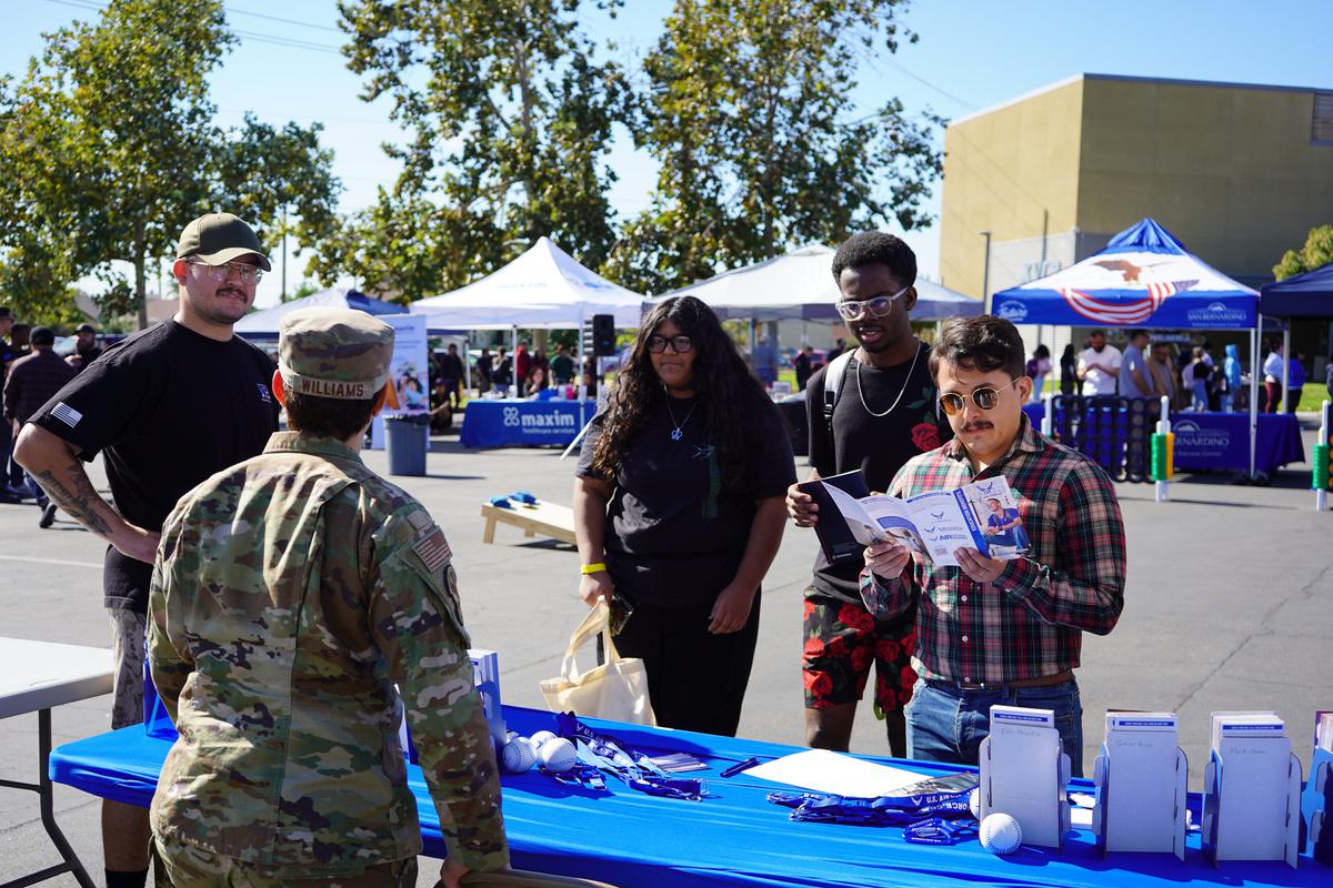 Students checking out a booth during the Veterans Day event