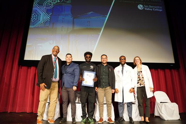 A group photo of people presenting on stage at the Annual Pharmacy Technology Day