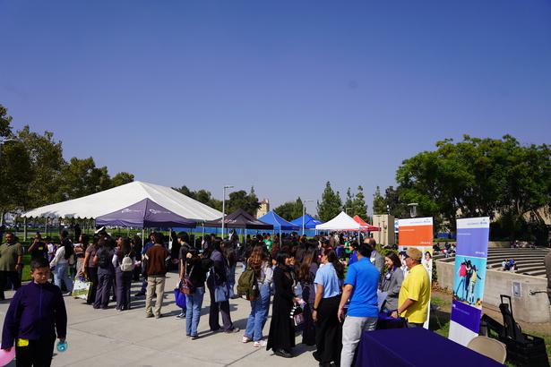 Students walking the Campus Walkway checking out different booths