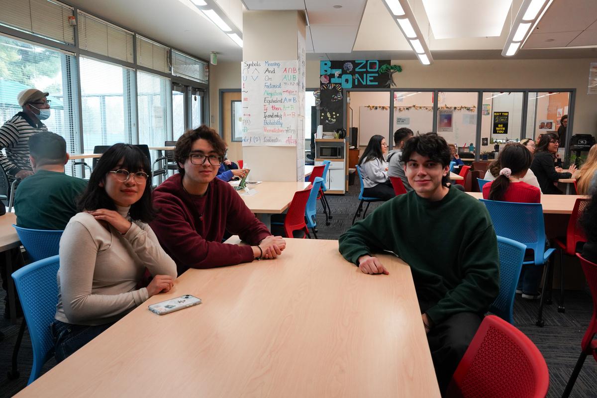 Students sit around a table in the STEM-MESA center