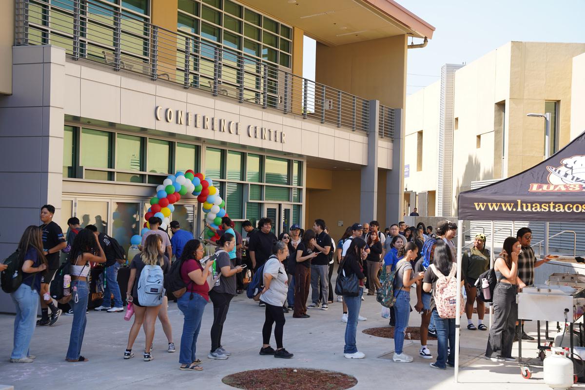 Students lining up for tacos in front of SBVC's Business Building