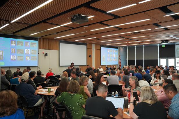 SBVC Business building (B-100) filled with Faculty and staff watching someone speak