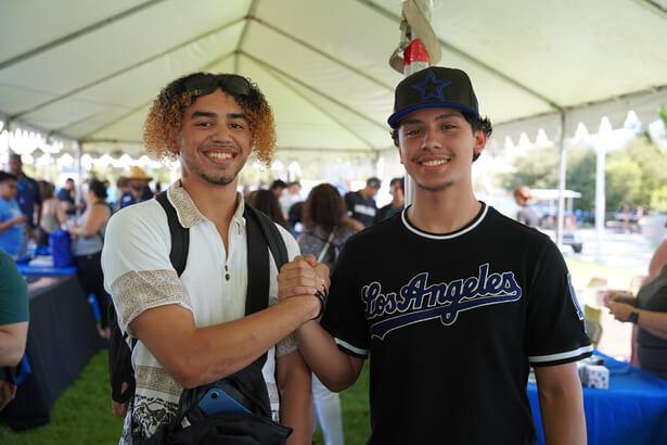 Two boys posing and locking arms 